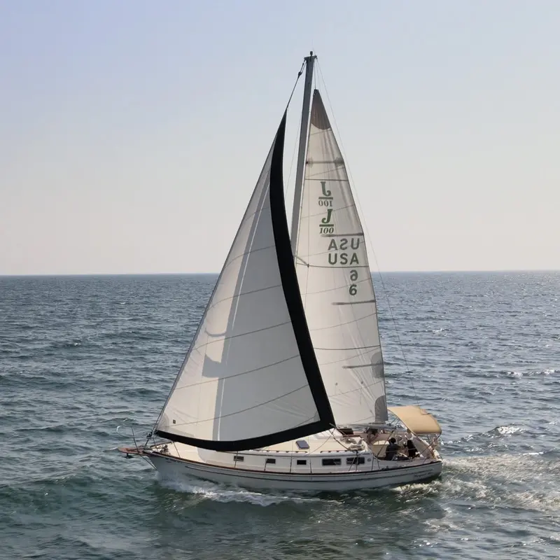 The Margaret Ann under sail on open water on a hazy day